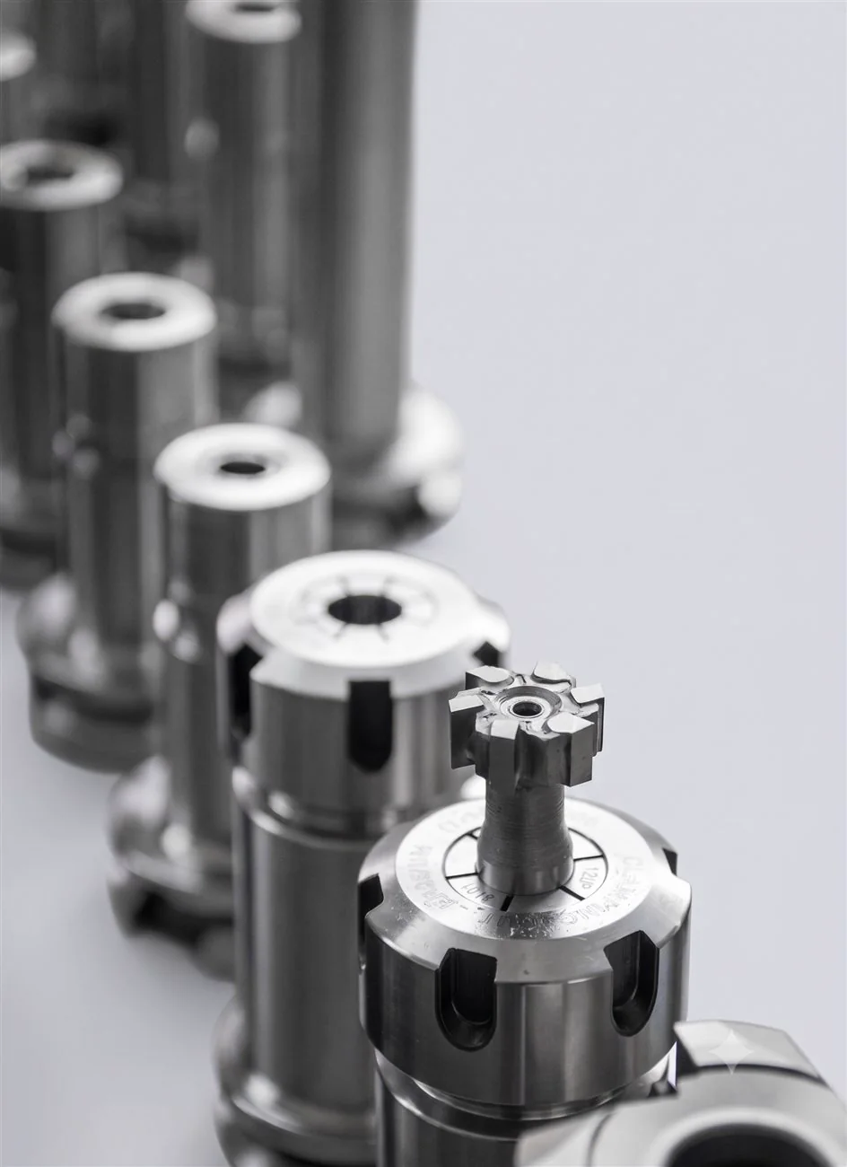 A line of precision-turned collet bodies with a milled cutter