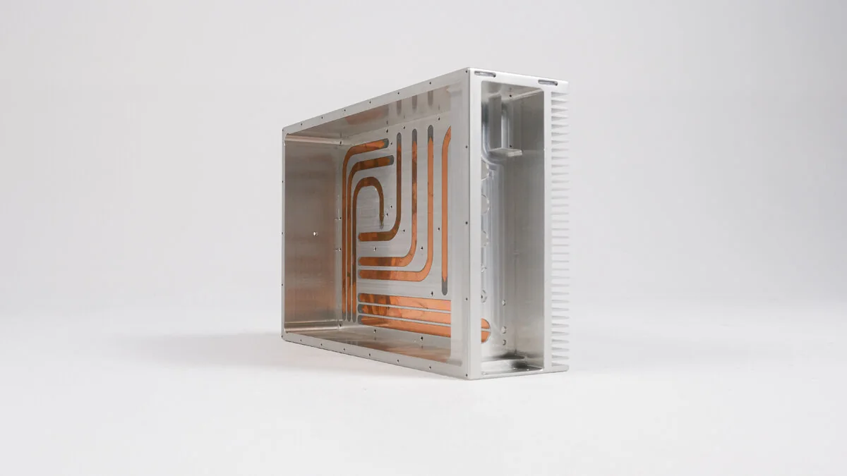 Aluminum chassis with copper cooling channels